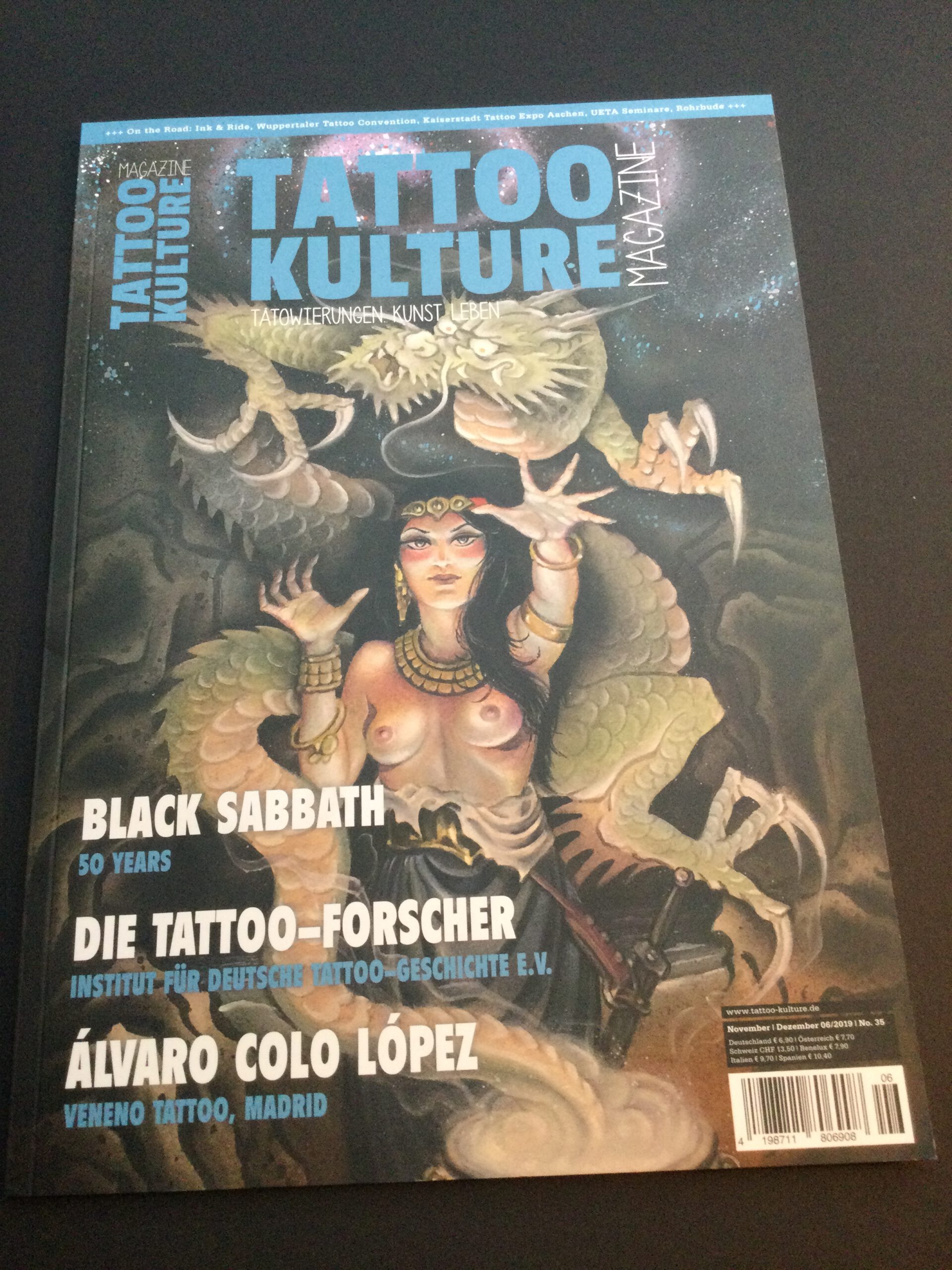 A sorceress surrounded by a green dragon on the front page cover for Tattoo Kulture magazine