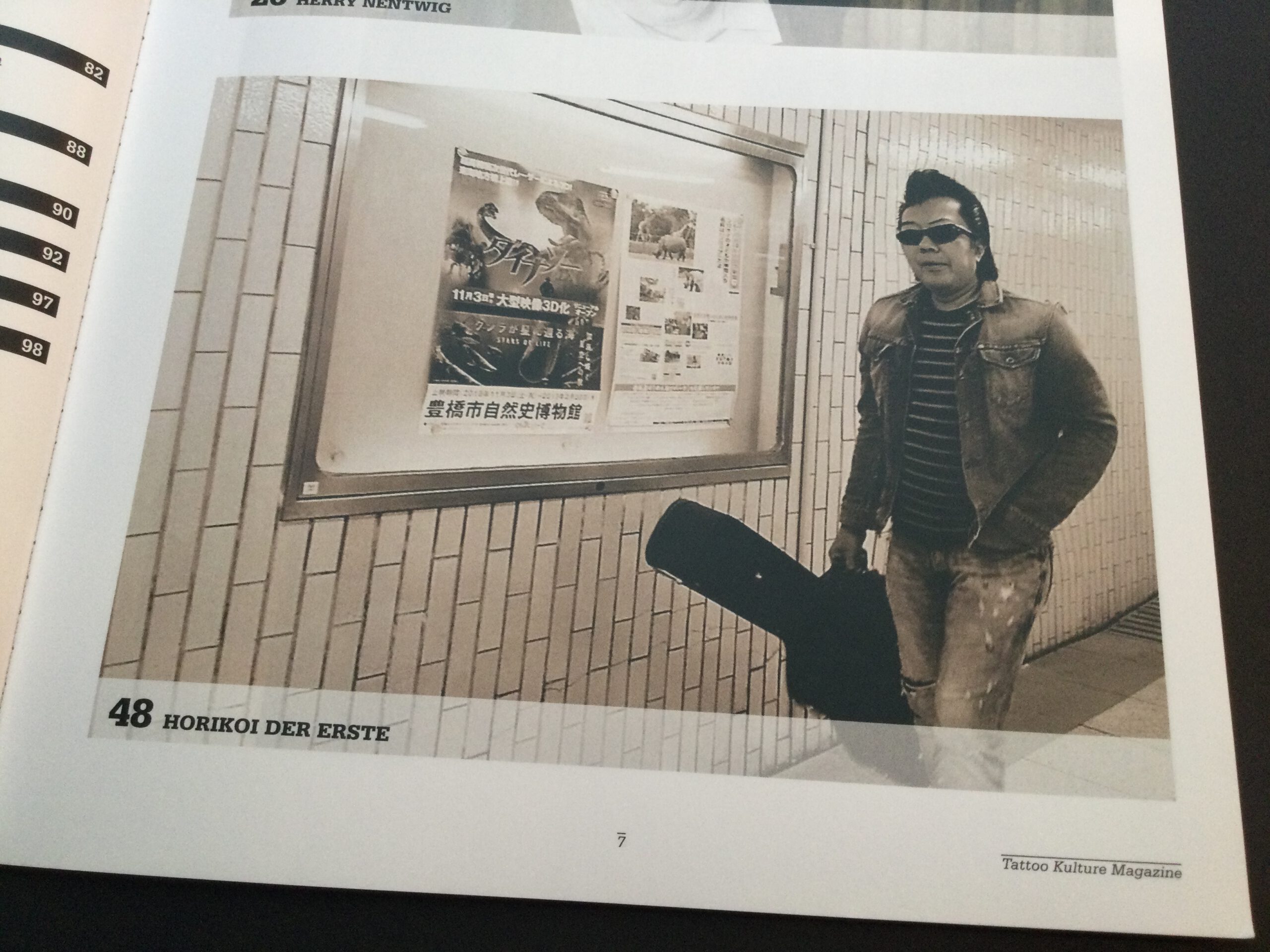 Man with guitar case in Nagoya subway