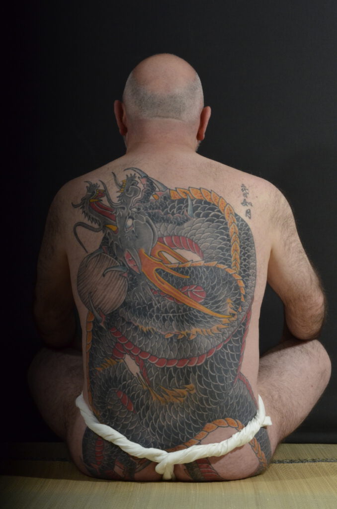 Man wearing Fundoshi with Black Dragon tattoo on his back. A Fundoshi is a traditional Japanese cloth worn at Festivals.