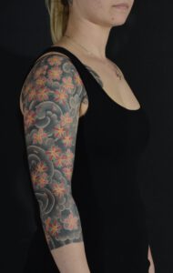 Cherry Blossum Tattoo on middle aged women. Sakura with Background.