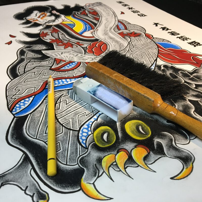 Drawing of Japanese women holding a scroll. She is sitting on a spider.